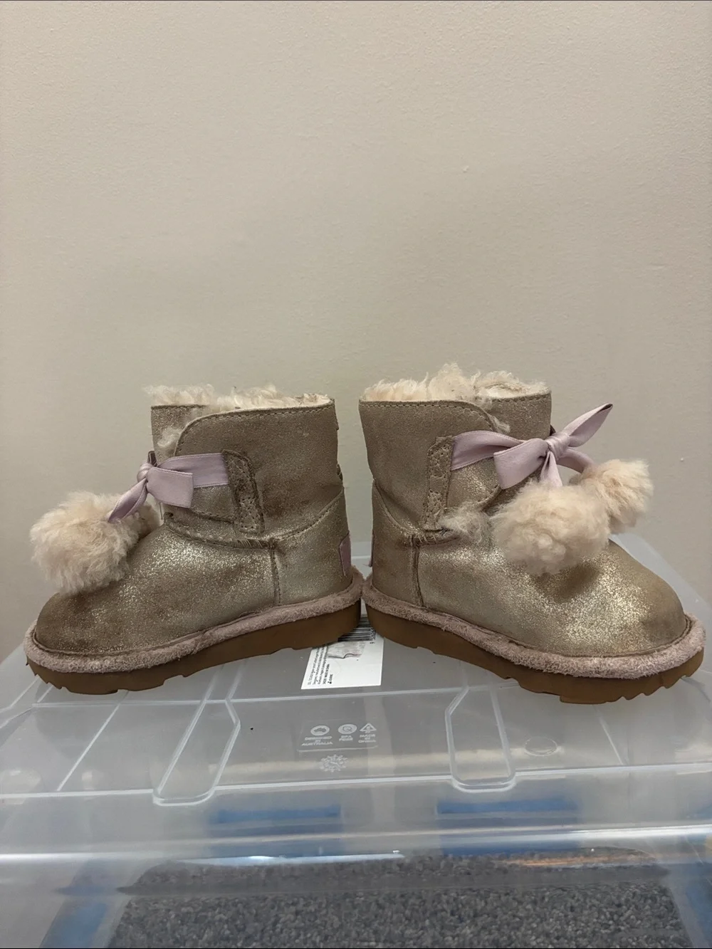UGG Kids Metallic Gold Pom-Pom Boots with Pink Ribbon